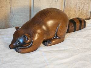 lot 22 image: MCM Sarreid Ltd. Carved Raccoon Figure (22 inches long)