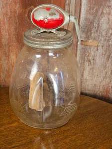 lot 46 image: Daisy No. 8 Glass Jar and Paddle Butter Churn