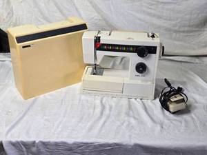 lot 16 image: Nelco Sewing Machine with Carrying Case