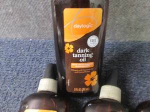 lot 79 image: 7- 8 oz Daylogic Dark Tanning Oil...