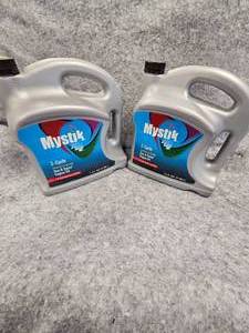 lot 26 image: Mystick JT4 Synthetic 2 Cycle Oil, 1 Gallon Jugs