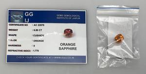lot 47 image: GGIJ 6.80 Ct. (LAB CREATED) Cushion Cut Orange Sapphire With Card