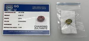lot 55 image: GGIJ 6.85 Ct. (LAB CREATED) Oval Cut Changing Zultanite With Card