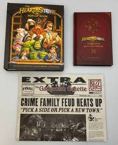 lot 97 image: Three HEARTSTONE Collectibles Including Pop Up Book, 2016 Gadgetzan Gazette Promotional Poster & More