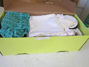 lot 320 image: Handmade doilies and crochet table coverings.