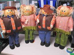 lot 385 image: Clique of (4) straw scarecrow ornam...