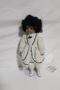 lot 23 image: Vintage Porcelain Doll with Polka Dot Dress and Hat