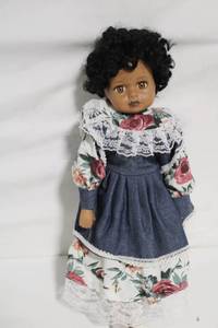 lot 25 image: Vintage Porcelain Doll with Floral Dress and Curly Hair