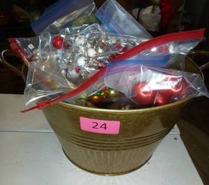 Metal bucket full of christmas bulbs and ornaments