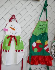 A whole wall full of hanging decorations and aprons