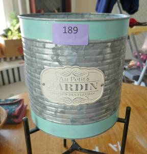 Cute metal planter on foldable stand and hanging bulb and dragonfly