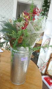 Tall metal planter full of dried flower supplies