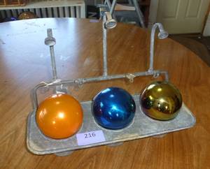 old wash sink looking planter and 3 gazing balls