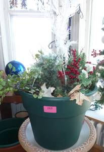 large plastic planter full of faux greenery