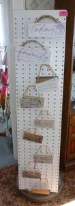 Rotating Pegboard Display with wall hangings 62 inches tall