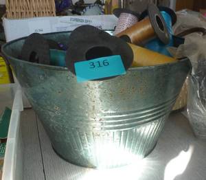 Metal bucket full of curling ribbon