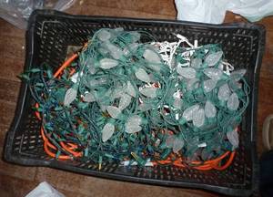 crate of christmas lights, extension cords, flags