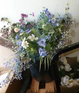 tall planter full of spring silk flowers, a box of white tulips and some roses