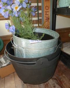3 planters, the 2 black ones look like cast iron but are plastic, sign and a sunflower attached to the lattice