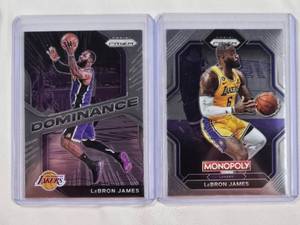 lot 29 image: Lot of 2 LeBron James Cards - 2022-23 Panini Prizm Monopoly PS7, 2020-21 Panini Prizm Dominance No. 17