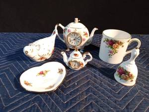 lot 42 image: Royal Albert Old Country Roses England dove pomander, 3.25 teapot with clock, England bell, 6 teapot with clock, Happy Anniversary heart trinket dish, Indonesia mug.