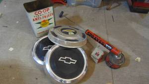 lot 91 image: 3 Metal Hub Caps, Coop Can, Bug Spayer and International Harvester Rivets