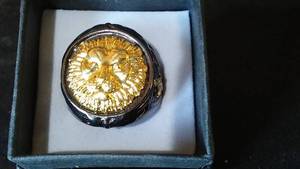 lot 981 image: Charcoal Grey Colored Metal Ring with Lion Head Design.