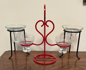 lot 252 image: Danish Red Metal Candle Holder and Pair of Black Metal Candle Holders