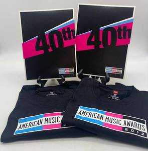 lot 297 image: Set of 2 American Music Awards 2012 T-Shirts and Memorabilia