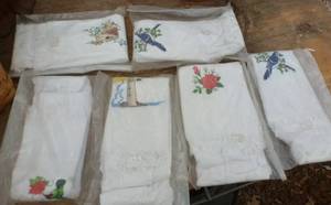 lot 257 image: SIX embroidered hand towels and wicker basket