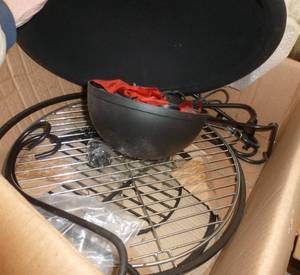 lot 319 image: Fake outdoor grill display, the red ribbon blows around to look like fire