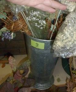 lot 9 image: Metal planter full of sprigs of green and fill in stuff