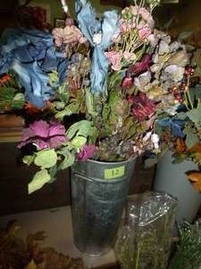 lot 12 image: Metal planter bursting with various flowers and colors