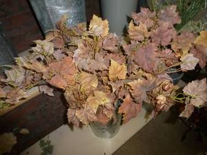 lot 19 image: Metal planter with lots of fall leaves