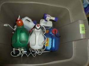 lot 88 image: Tote of chemicals, most are 12 to 34 full