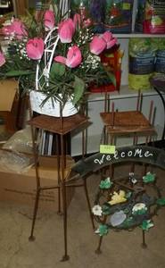 lot 122 image: TWO rusty metal stands with a metal welcome sign and a baset of pink tulips