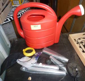 lot 497 image: Red watering can, a wind chime and a thistle feeder