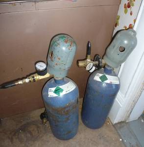 lot 574 image: Two small helium tanks (empty)