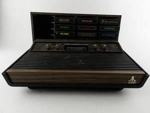 lot 8 image: ATARI Video Computer System with 12 Games -Has 4 Gaming Remotes (Not Pictured)