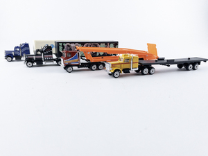 lot 118 image: Group of 4 Vintage Diecast Semi-Trucks -Good Year, Save Our Wildlife, Race Trans, Tractor Trailer
