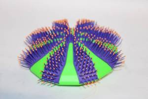 lot 254 image: Green and Purple Grooming Brush with Ergonomic Handle