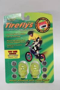 lot 300 image: Tireflys Motion Activated Valve Stem Lights - Green Skull Shape