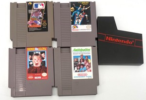 lot 434 image: Set of 4 Nintendo NES Game Cartridges with 1 Storage Case