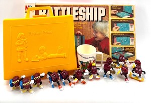 lot 630 image: Vintage Battleship Game, Walt Disney Mug & California Raisin Figures Set & Fisher Price Case