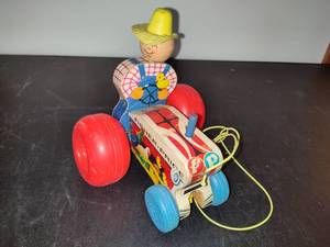 lot 30 image: VIntage Fisher Price Farmer on a Tractor Pull Toy
