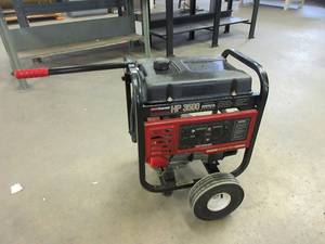 lot 203 image: COLEMAN POWERMATE GAS POWERED GENERATOR