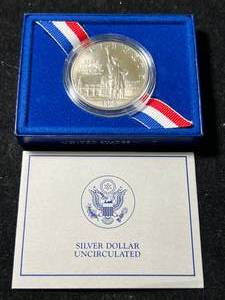 lot 87 image: 1986 US ELLIS ISLAND COMMEM SILVER DOLLAR