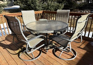 lot 13 image: Circular Metal Glass Top Patio Table with Four Chairs