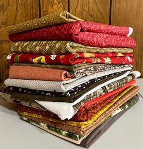 lot 155 image: Variety of Reds, Browns and Neutral Sewing Remnants