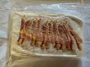 lot 104 image: 3.75lbs Pre Cooked Bacon-12 slices per sheet-25 sheets